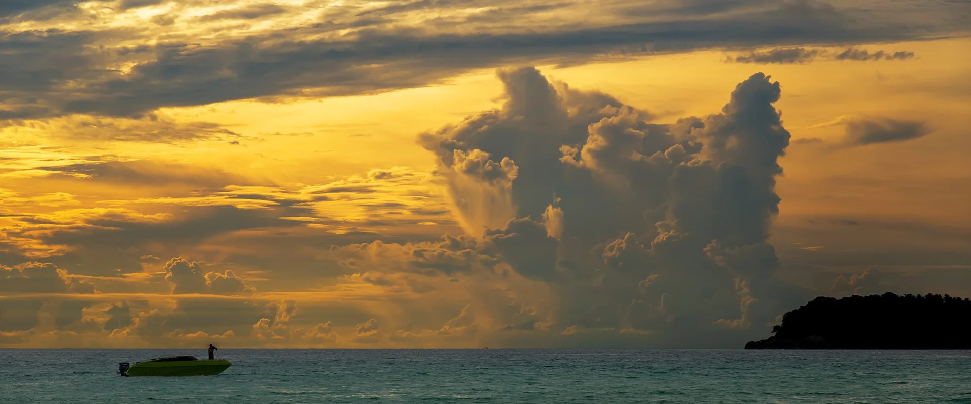 A golden sunset over Koh Pu from Kata Beach · Phuket@photographer.net, CC BY 2.0