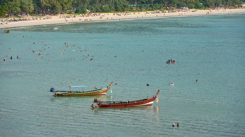 Kata Yai Beach from above: longtail boats and swimmers · Radek Kucharski, CC BY 2.0