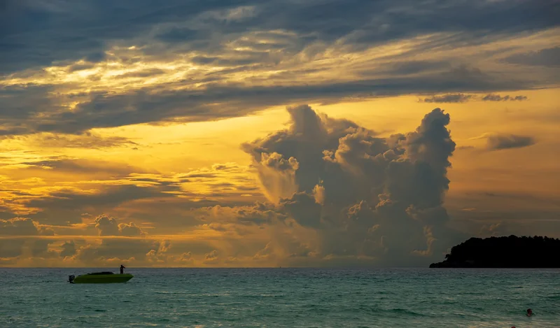 A golden sunset over Koh Pu from Kata Beach · Phuket@photographer.net, CC BY 2.0